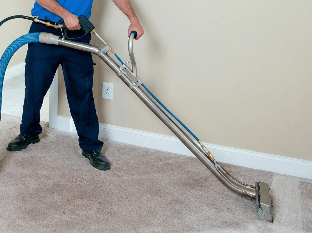 Professional operating a liquid removal machine on a carpeted floor in South Bend, IN